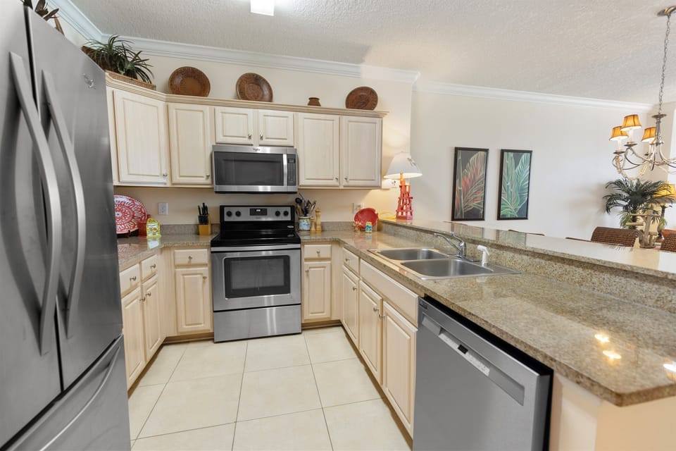 Cook your favorite meals in this fully equipped kitchen with granite countertops, stainless steel appliances, and everything you need for a comfortable stay.