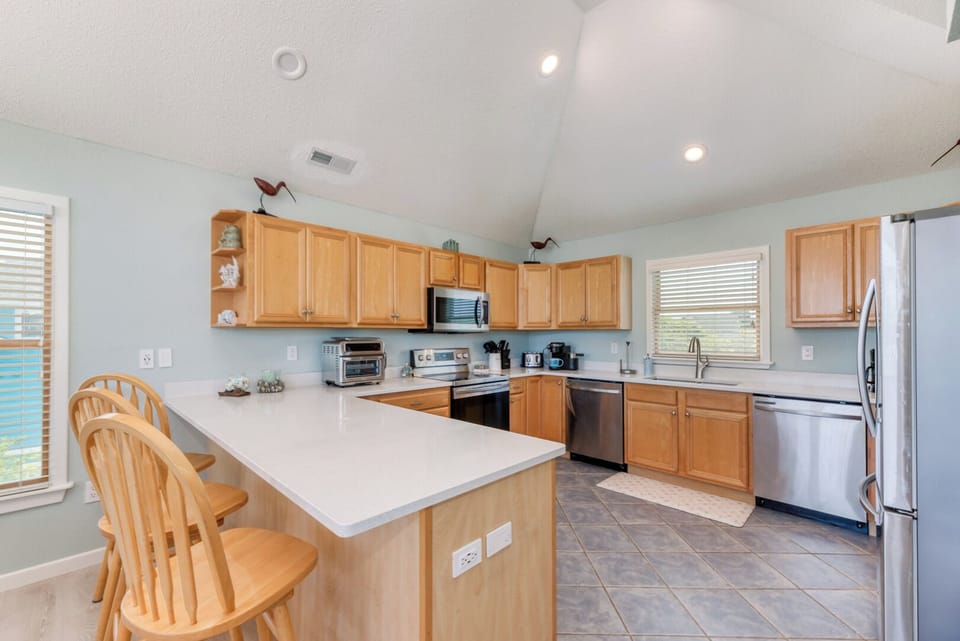 Kitchen with Bar Seating on Third Level