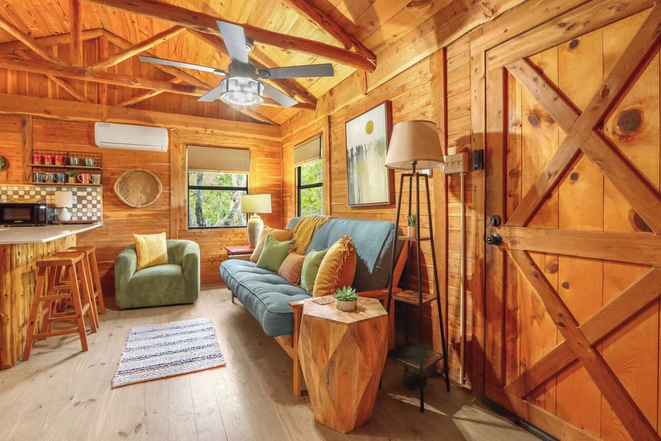 To the right of the entry door is the living room of the cabin.