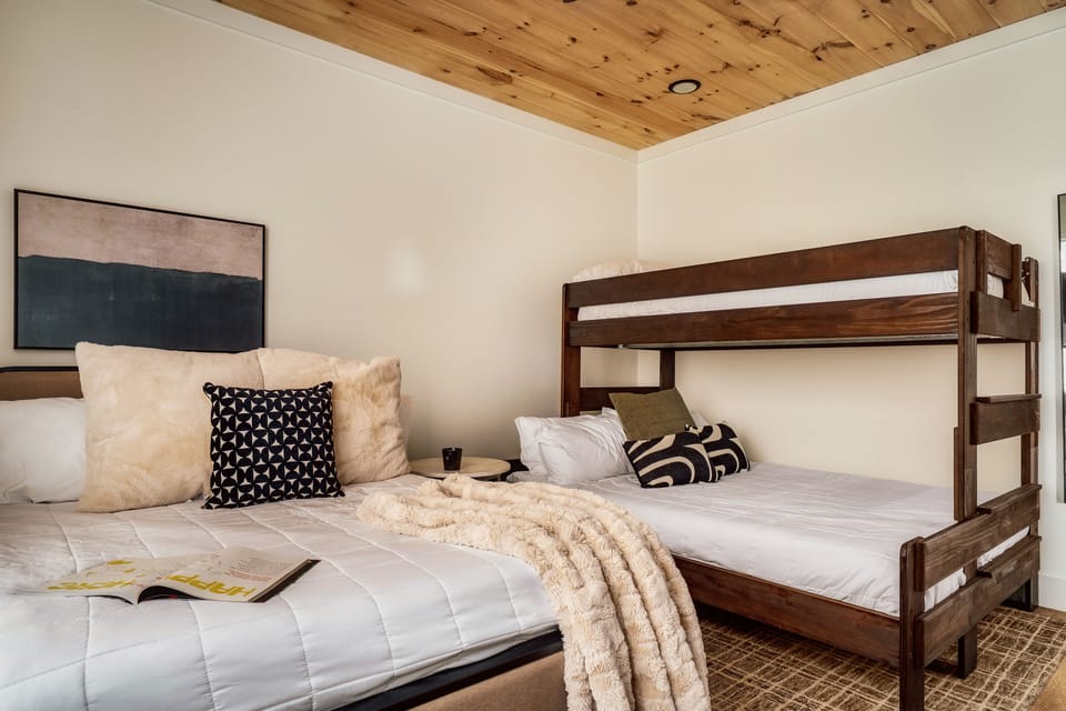 Large Five Bedroom Cabin Rental Lodges at Reedmont Sevierville P - Bedroom with queen bed, and twin over double bunk bed.