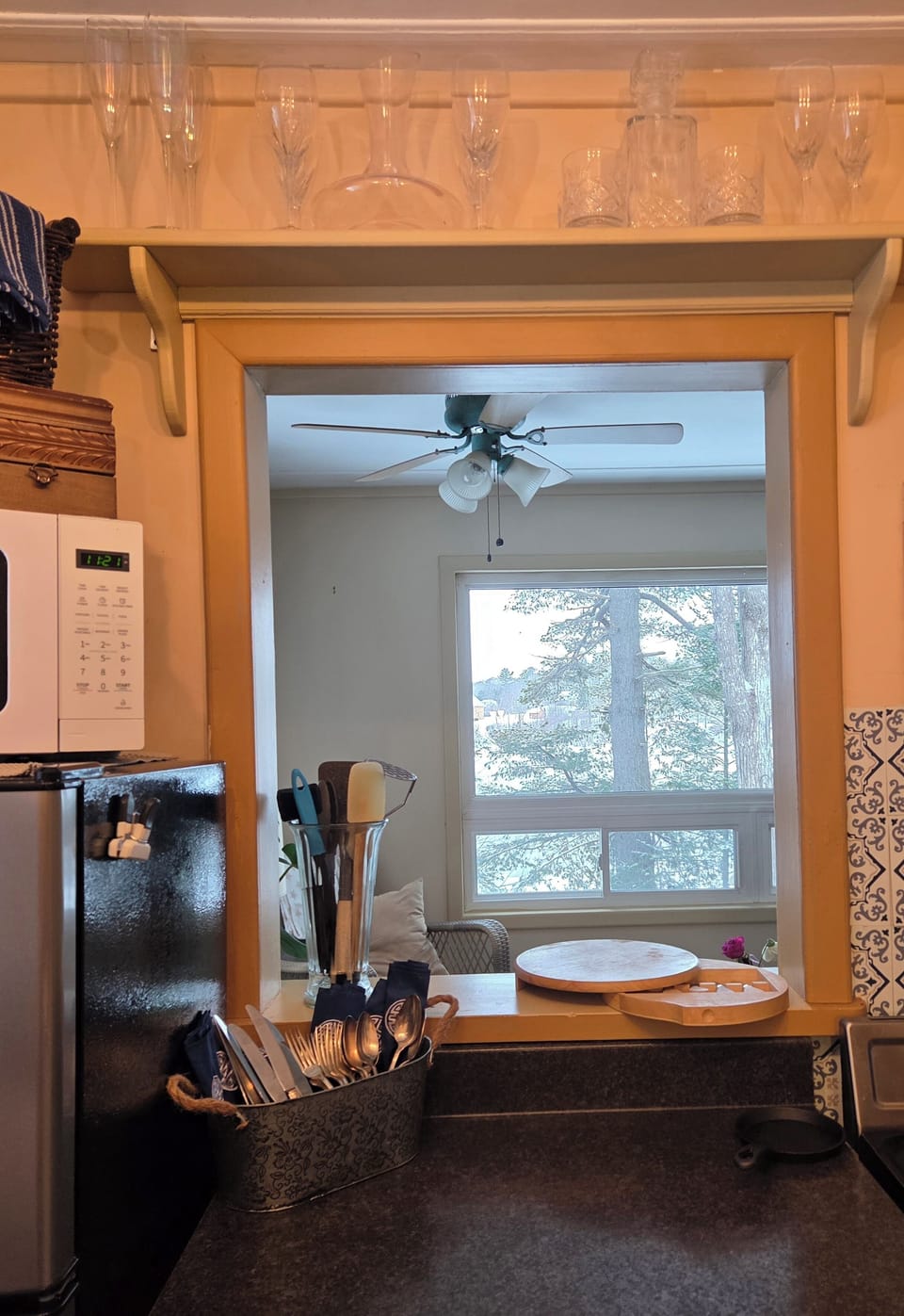 An indoor window in the galley kitchen allows the cook to take in the bay view.