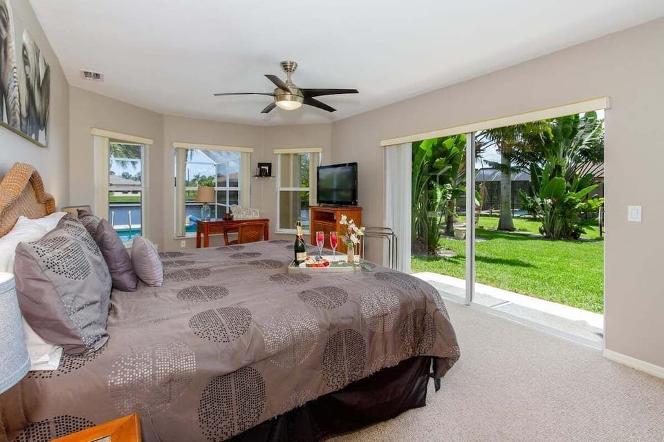 Main King Bedroom with Access to the Yard and View of the Lush Tropical Garden