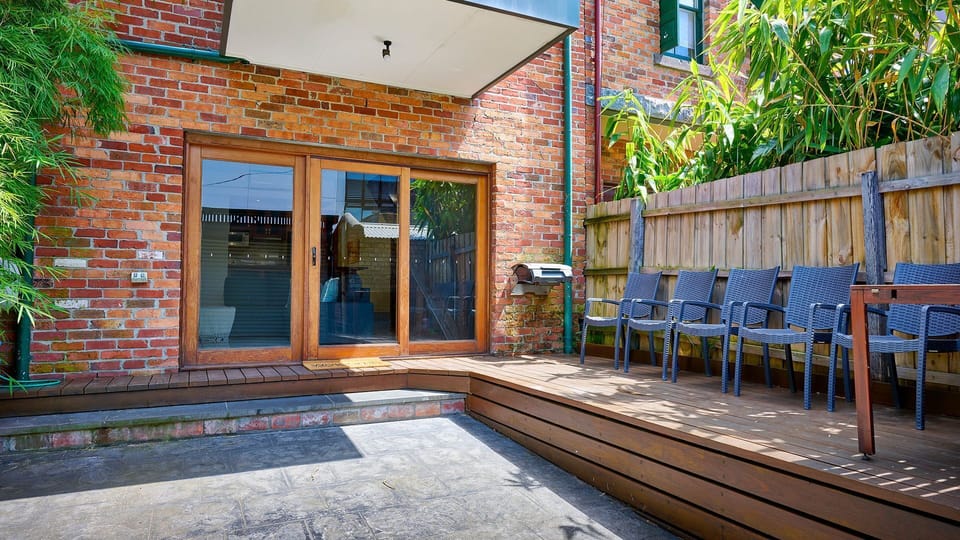 Private Courtyard: Secluded brick patio and raised timber decking ideal for quiet al fresco relaxation.
