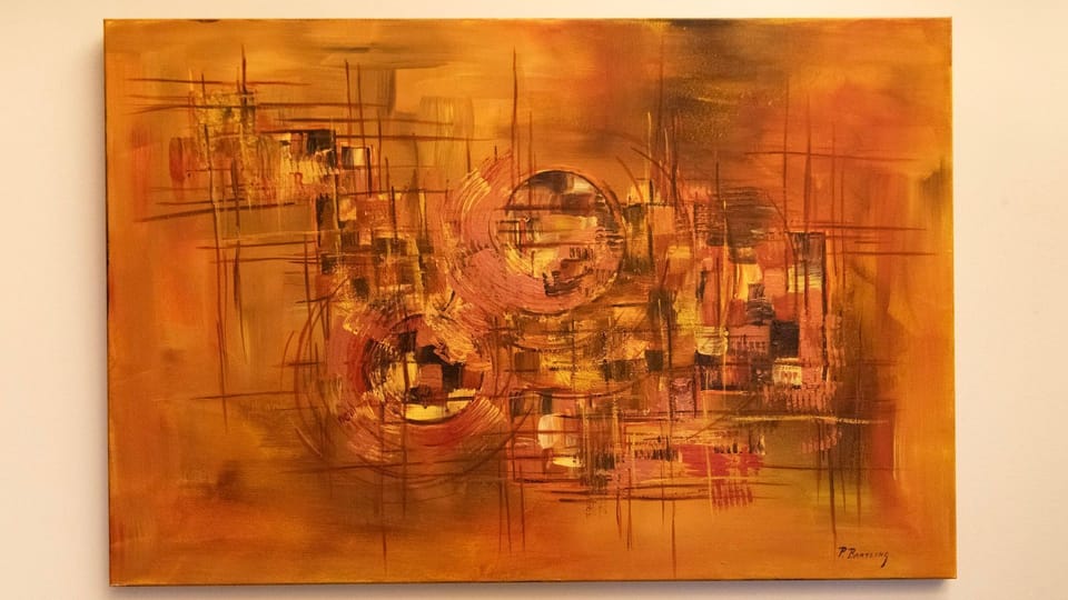 Warm Abstract Canvas: Eye-catching abstract painting adding rich amber tones and textural depth to the walls.