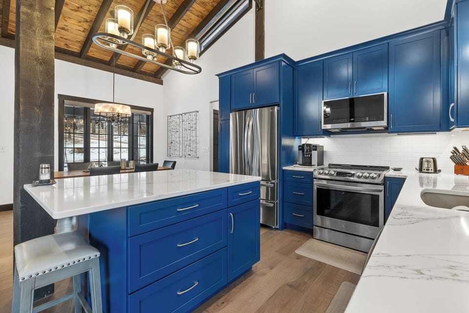 Bright blue cabinets to elevate your spirits in the well appointed kitchen