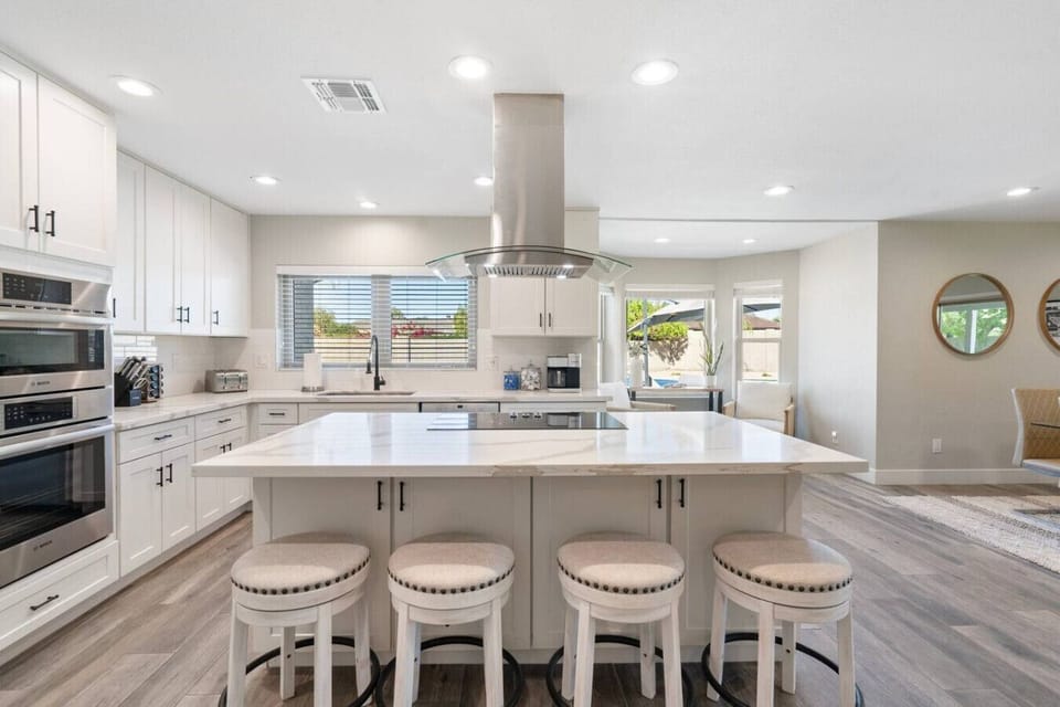 Gather around the oversized island in a fully equipped kitchen designed for entertaining and shared meals.
