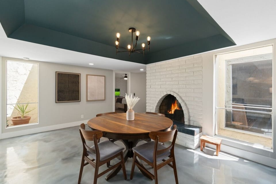 Share meals and make memories in this inviting dining space featuring a cozy fireplace.