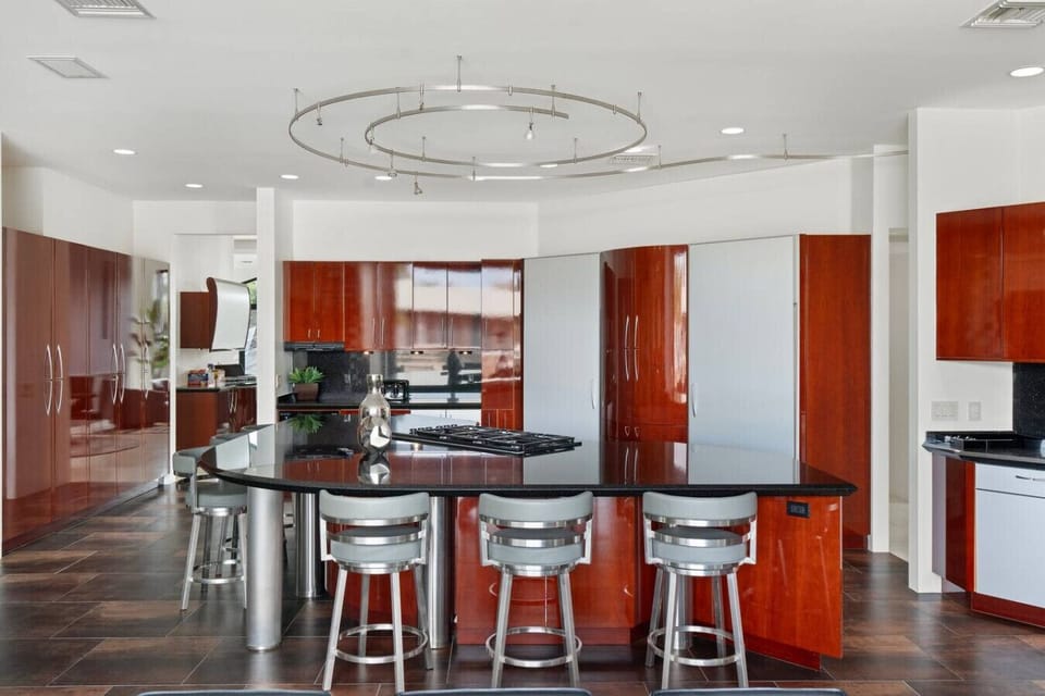 Gourmet kitchen with oversized island offers plenty of seating for casual meals and conversation.