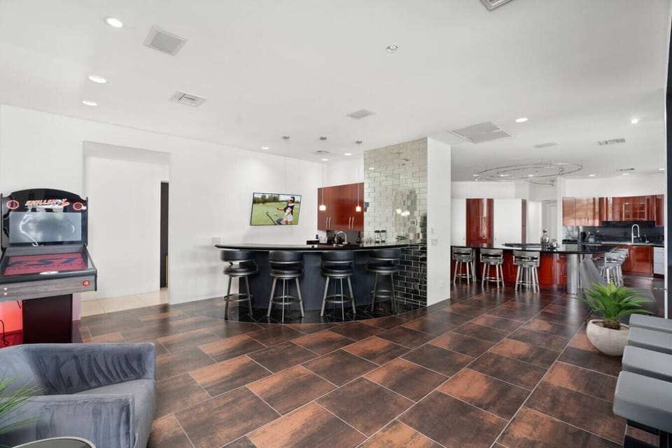 Open gathering space with arcade games, bar seating, and plenty of room to socialize.