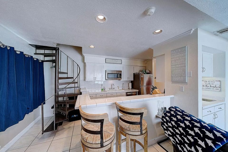 Kitchen with staircase leading to upstairs bedrooms
