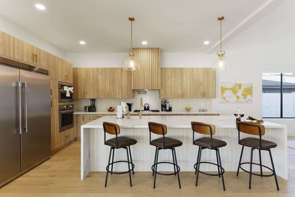 Fully equipped kitchen with stainless steal appliances and a kitchen island with bar seating for 4 guests.