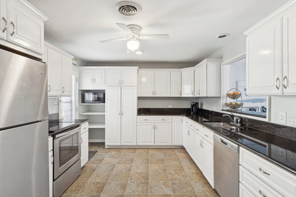 Fully equipped kitchen with stainless steel appliances.