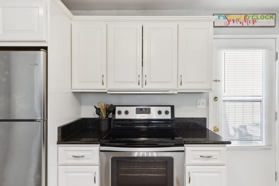 Fully equipped kitchen with stainless steel appliances.