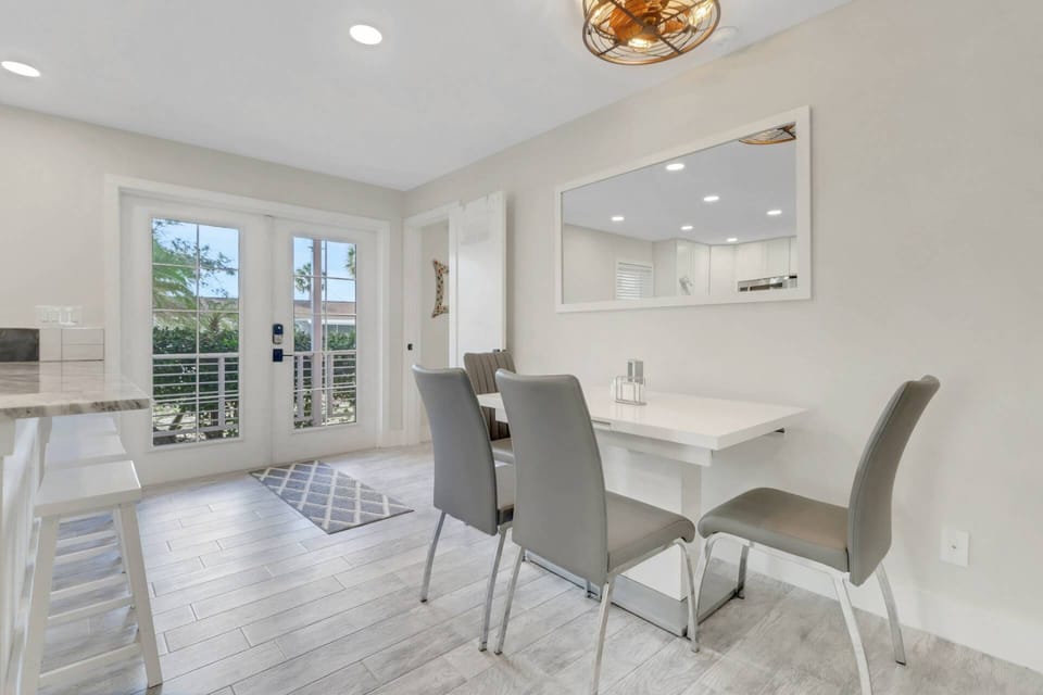 An eating counter with bar stools and dining table for 4 provide plenty of space for all.