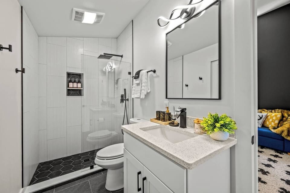 Modern and minimal, this bathroom offers a spacious shower and stylish fixtures, perfect for refreshing moments.