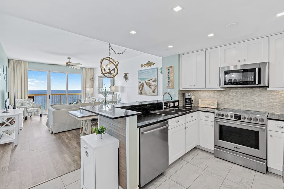 Imagine waking up to endless ocean views from your open-concept retreat—where the living room, dining area, and fully-equipped kitchen flow seamlessly together, all bathed in coastal light.