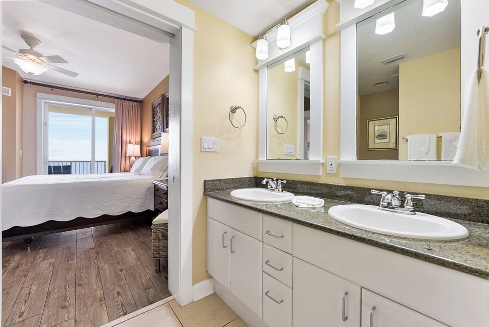 Your spacious bathroom features dual vanities and granite countertops, connecting seamlessly to your comfortable bedroom retreat.