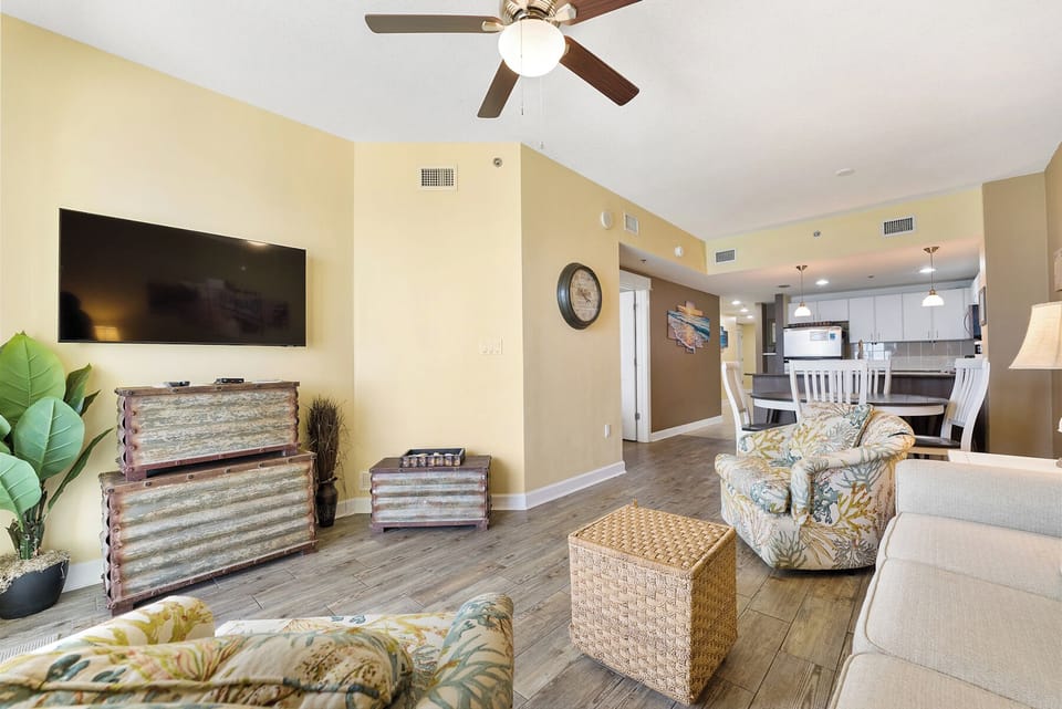 Relax in your spacious living room with tropical-inspired furnishings, a large flat-screen TV, and open flow to the fully-equipped kitchen.