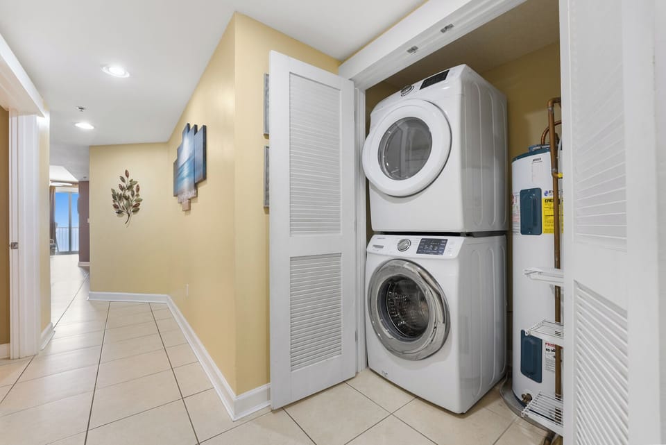 Your laundry stays fresh with convenient in-unit washer and dryer, perfectly tucked into this hallway alcove for easy access.