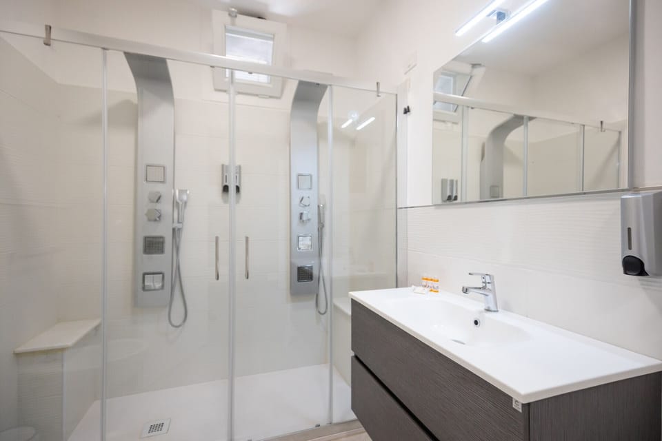 Shower, hair dryer, towels, toilet paper