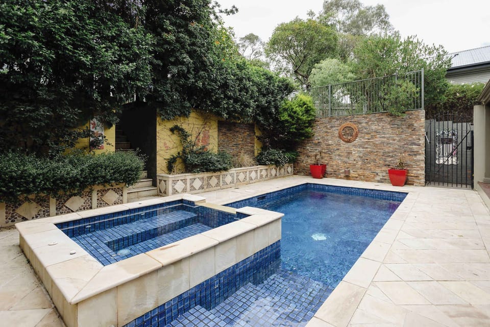 Escape to your private retreat with a spacious pool and an attached shallow wading pool, complete with a stylish deck and outdoor kitchen – perfect for relaxation and entertaining. Note: spa is not functional or included, and the pool is unheated.