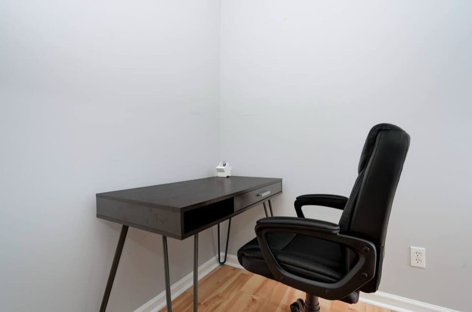 Bedroom 1: Your workspace awaits, perfect for tackling tasks and staying productive!