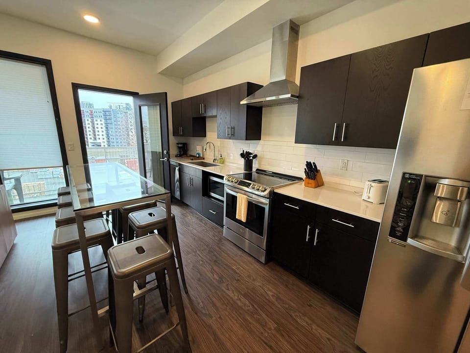 The stylish open kitchen offers ample space & every home comfort
