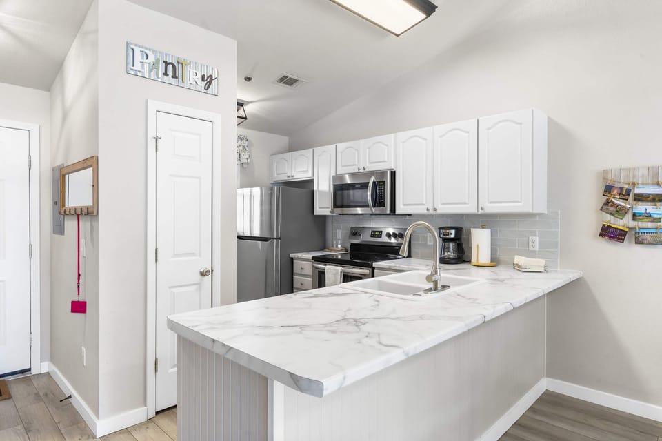 The open, airy kitchen offers ample space & every home comfort