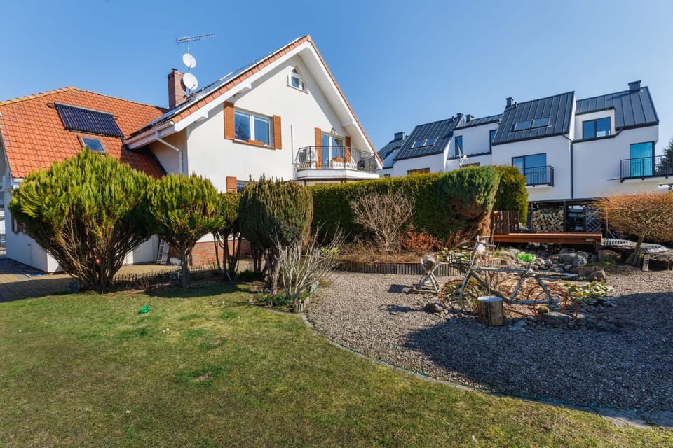 An exterior view of the property, showcasing a spacious garden and picturesque surroundings.
