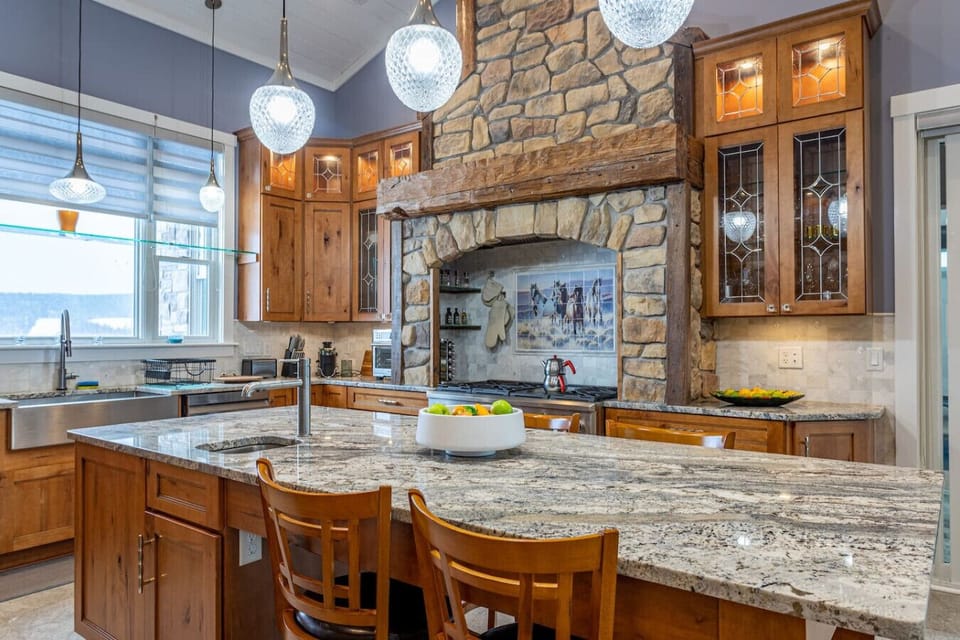 Kitchen island with granite countertop and pendant lighting