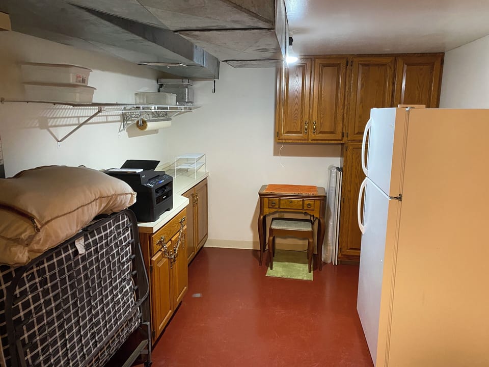 Laundry room and roll-a-way bed storage area