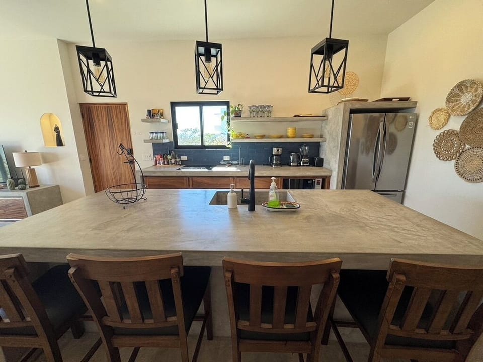 A welcoming kitchen island with four bar stools, perfect for meals, snacks, or mingling