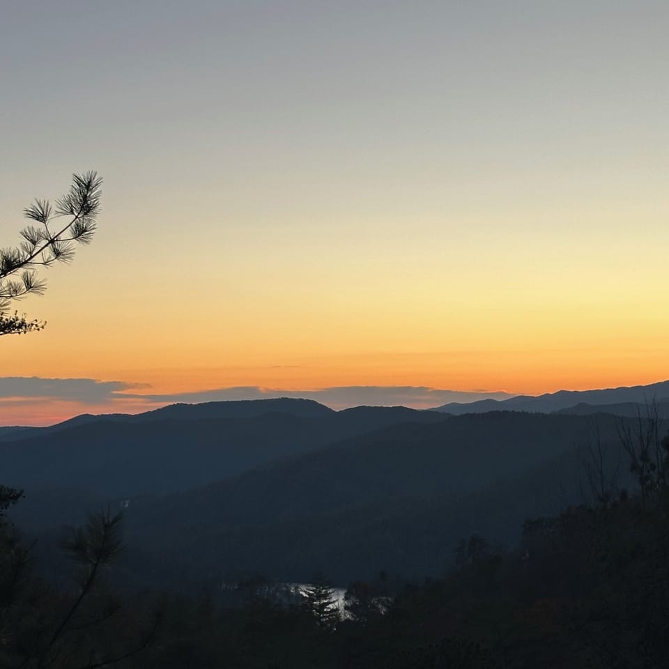 As the sun sets over Lake Jocassee and the Blue Ridge Mountains... 