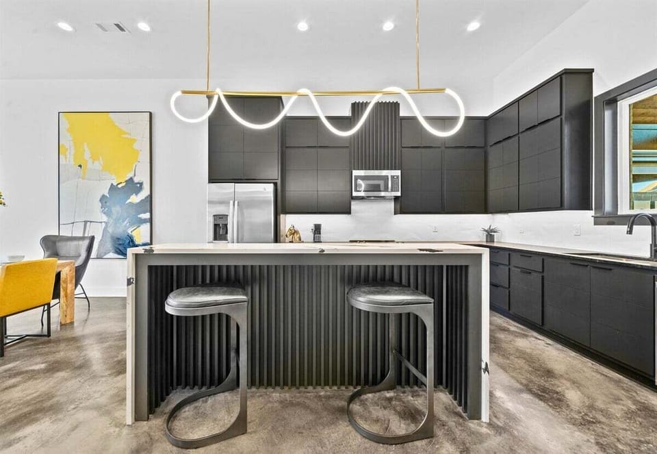 A beautifully crafted kitchen featuring high-end finishes, a functional island with seating, and clean lines that perfectly balance form and function.