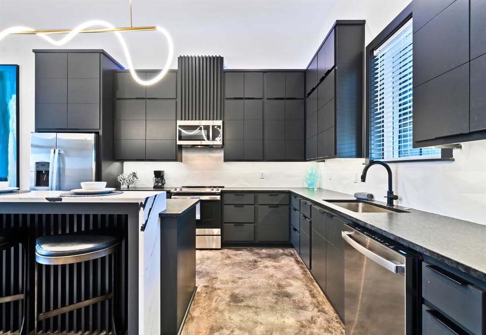 A thoughtfully designed kitchen that blends top-of-the-line appliances, sleek finishes, and an inviting island for casual dining or conversation.
