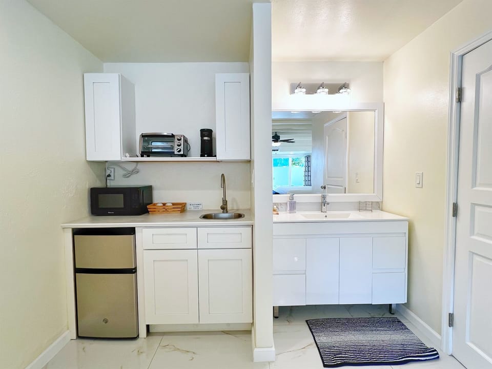 Snacks, coffee, and quick meals made easy in this compact and functional kitchen space.