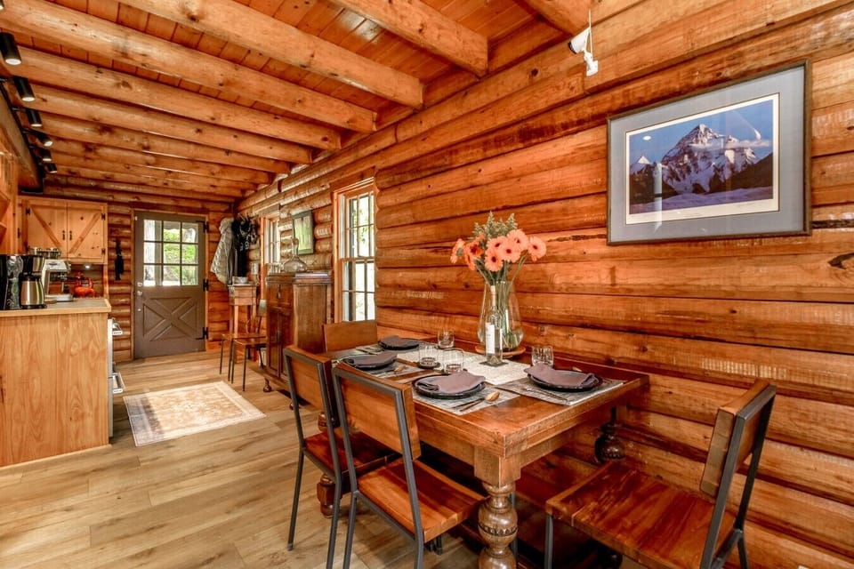 Antique dining table expands to seat 8 beside the galley-style kitchen.