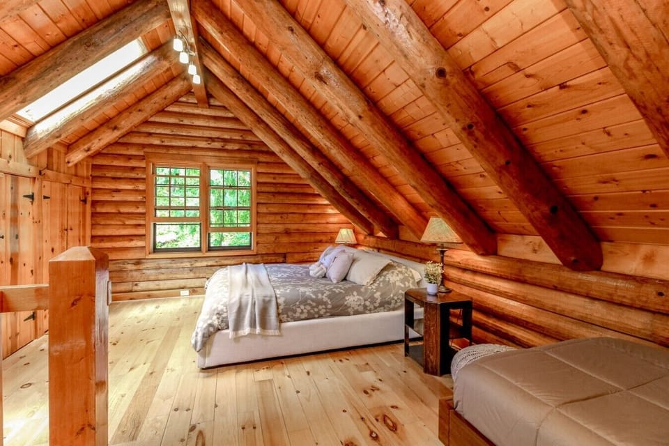 Second loft view showing the queen and twin sleeping setup.