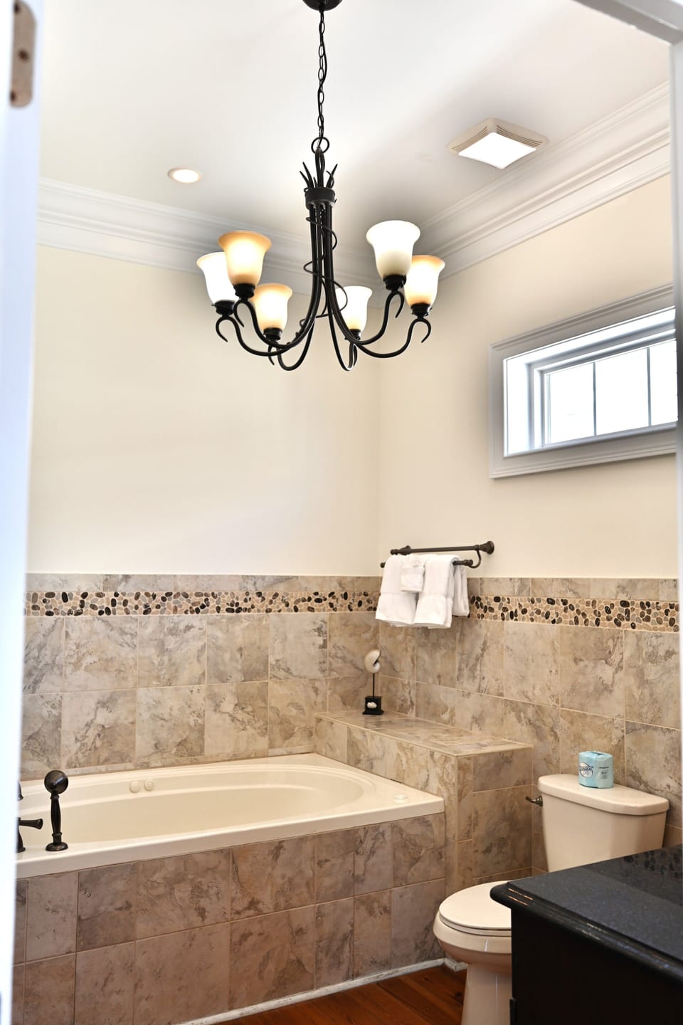 Full bathroom with granite counters, double sinks, and style.