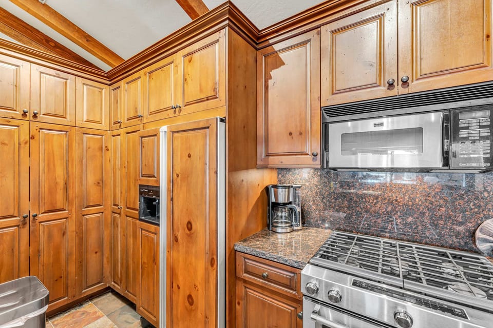 Kitchen: Drip coffee maker, toaster, Crockpot, cooking utensils, tableware
