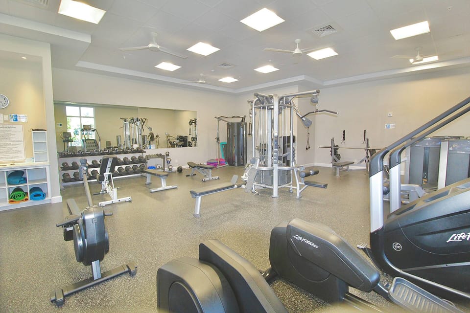 The new Fitness Center in the Main Clubhouse offers many different machine options and free weight lifting as well.