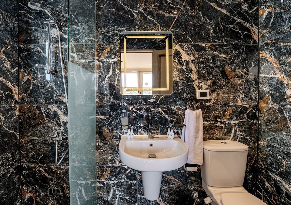 Suite, Balcony, River View | Bathroom | Separate tub and shower, eco-friendly toiletries, hair dryer, slippers