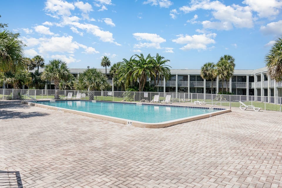 The ultimate vacation perk! Relax by the expansive resort pool, surrounded by palm trees and plenty of space to lounge.