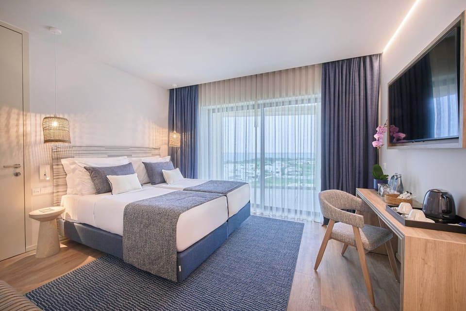 Twin Room, Sea View | Minibar, in-room safe, blackout drapes, iron/ironing board