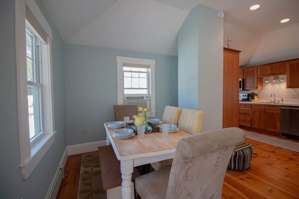 Charming dining nook with bench seating and large comfortable chairs.