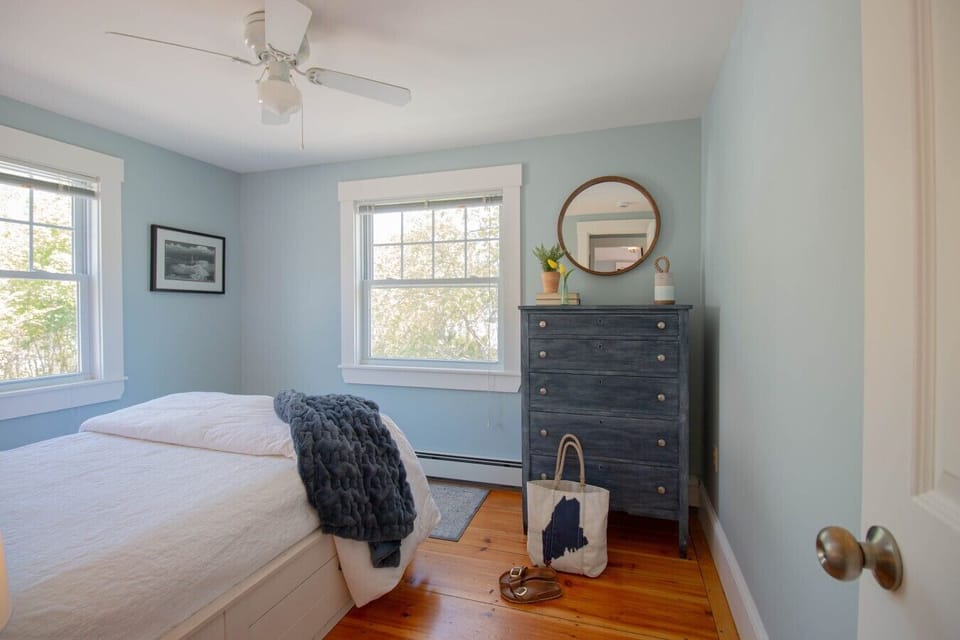 Full bed with large dresser for storage.
