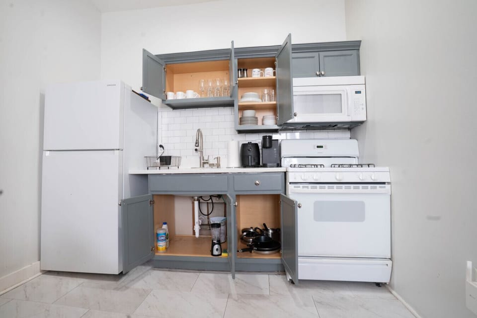 Fully-equipped kitchen — full-size fridge, gas range, dishwasher, microwave, coffee maker.
