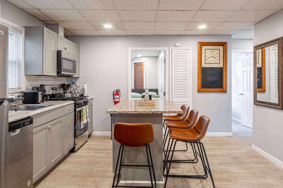 Floor 1 - Modern kitchen with granite island and stylish bar seating.