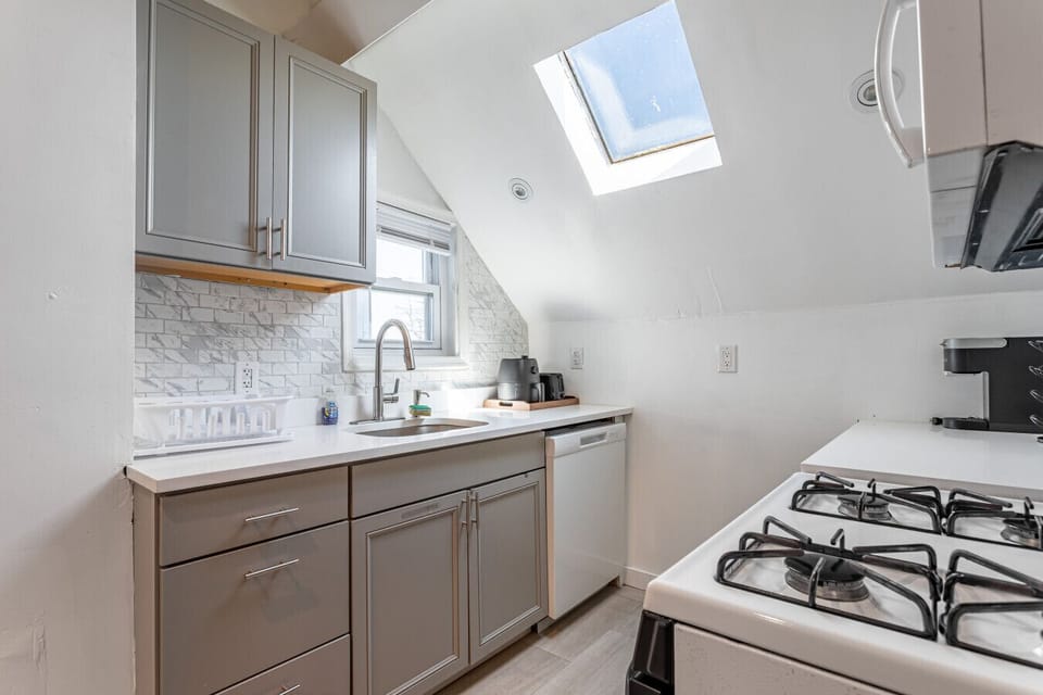 Chef`s kitchen — full-size fridge, gas range, dishwasher, microwave, coffee maker.