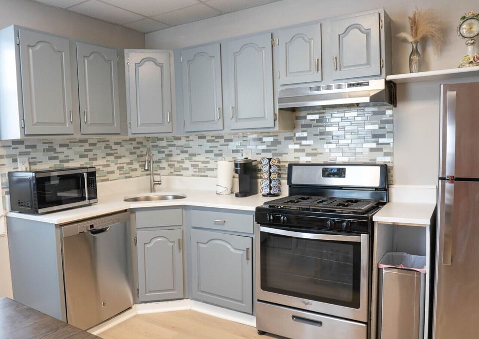 Full kitchen — fridge, gas range, dishwasher, microwave, coffee maker, all the tools.